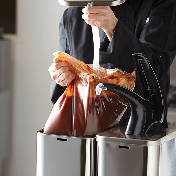 A person pouring Red Gold BBQ sauce into a bag of food.