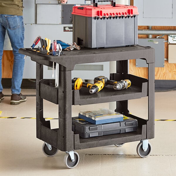 A black Lavex utility cart with a built-in tool compartment holding tools.
