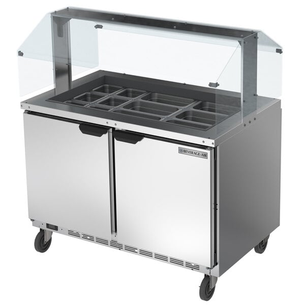 A Beverage-Air stainless steel refrigerated salad bar with a glass top on a counter.