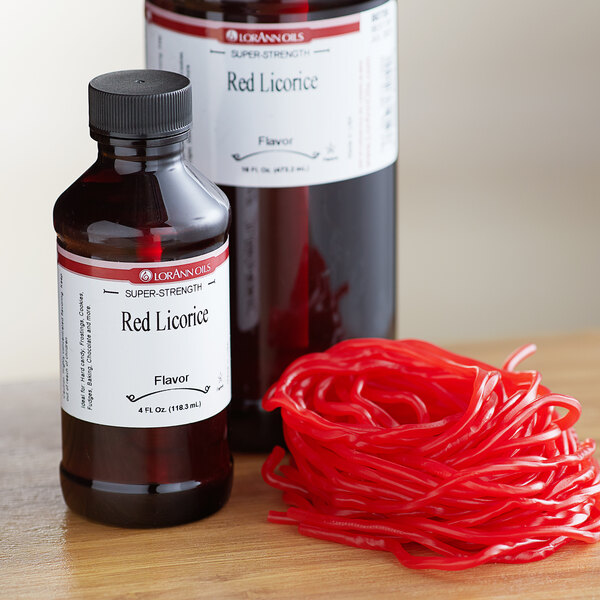 A bottle of LorAnn Oils Red Licorice flavoring on a counter with a label.