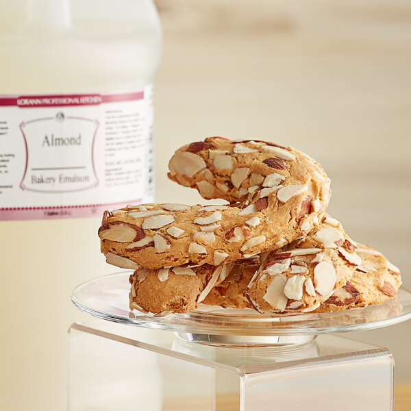 A close-up of a stack of almond cookies on a glass plate.