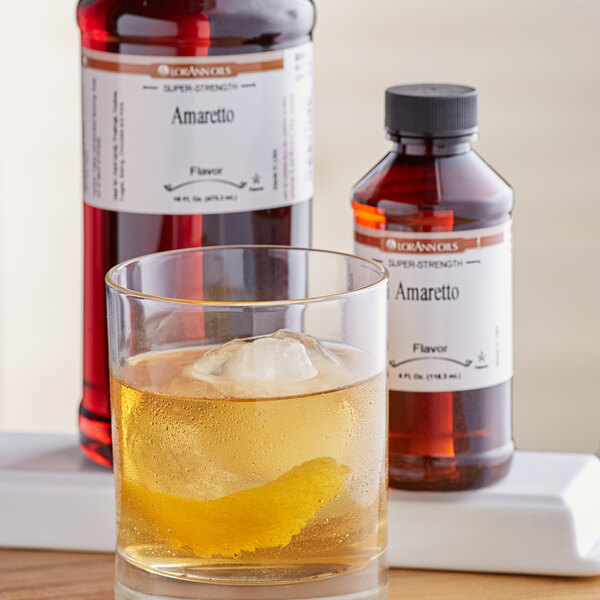 A glass of liquid with ice and LorAnn Oils Amaretto Super Strength Flavor.