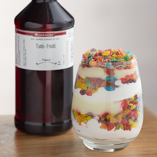 A close-up of a glass of fruity dessert with LorAnn Oils Tutti-Frutti flavor on the table.