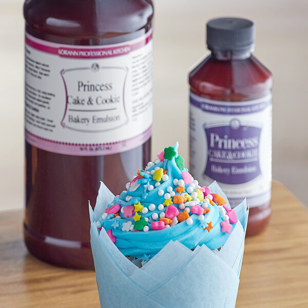 A cupcake with blue frosting and sprinkles with LorAnn Oils Princess Cake and Cookie Bakery Emulsion.