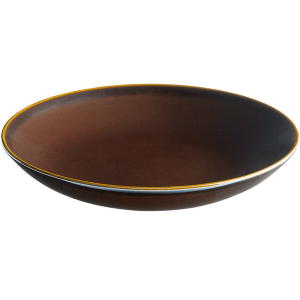A brown porcelain coupe plate with a white rim.