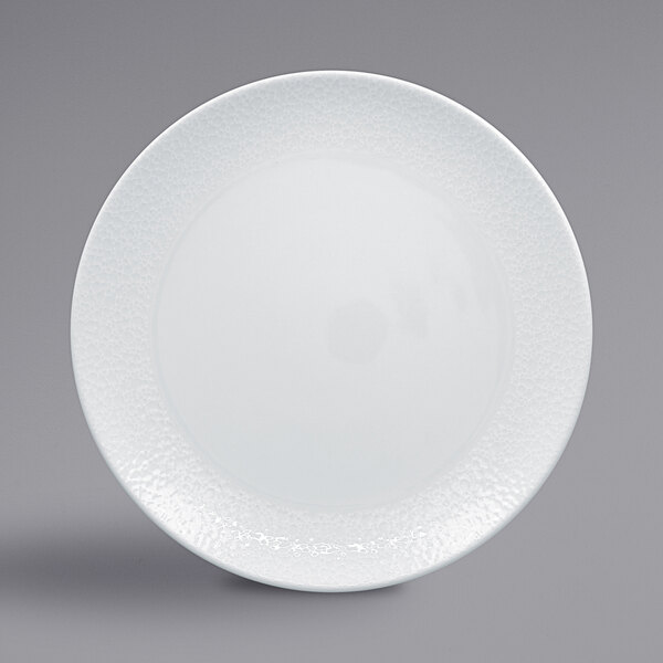 A white RAK Porcelain plate with a textured rim.