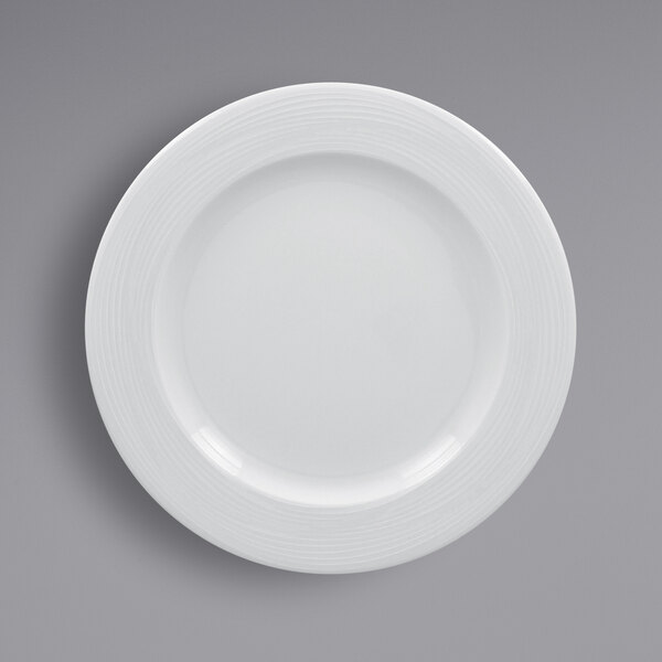 A white RAK Porcelain plate with a wide rim and a circular design.