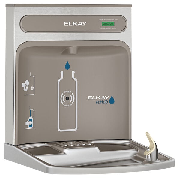 An Elkay light gray bottle filling station on a counter next to a water fountain.