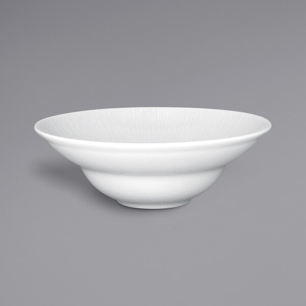 A RAK Porcelain bright white wide rim extra deep porcelain plate with an embossed design.