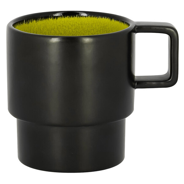 A black coffee cup with a yellow rim.