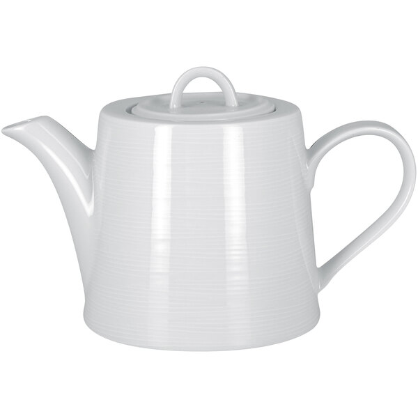 A close-up of a white RAK Porcelain teapot with a lid.