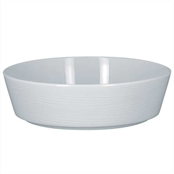 A RAK Porcelain bright white round stackable bowl with an embossed edge on a white background.
