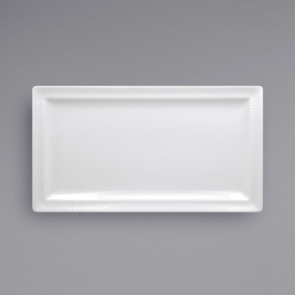 A RAK Porcelain bright white rectangular porcelain plate on a gray background.