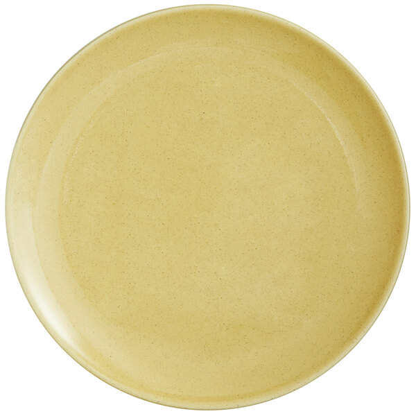 A close up of a yellow RAK Porcelain coupe plate with a glossy finish.