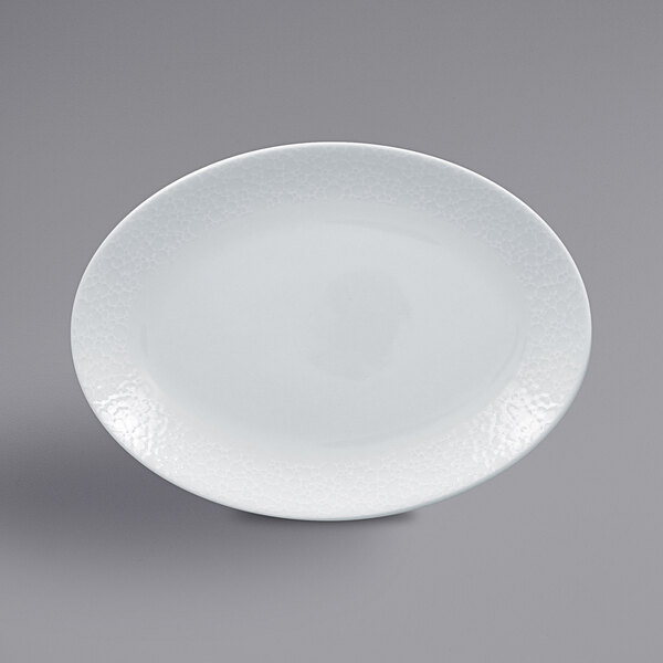 A white RAK Porcelain oval platter with a textured pattern.