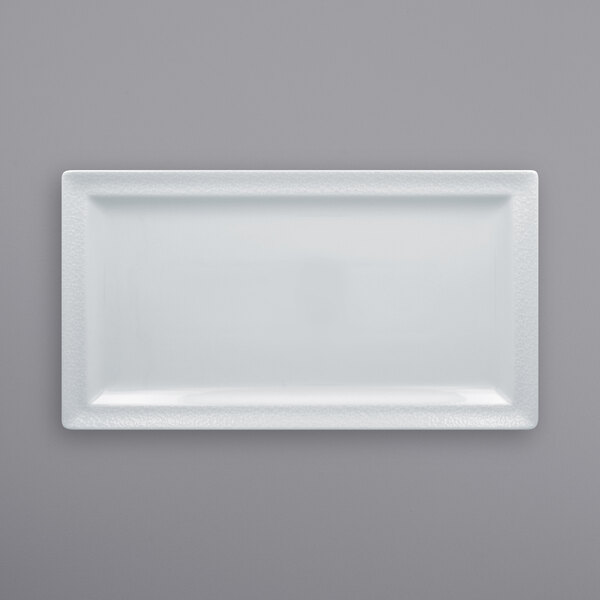 A bright white rectangular RAK Porcelain plate with an embossed design.
