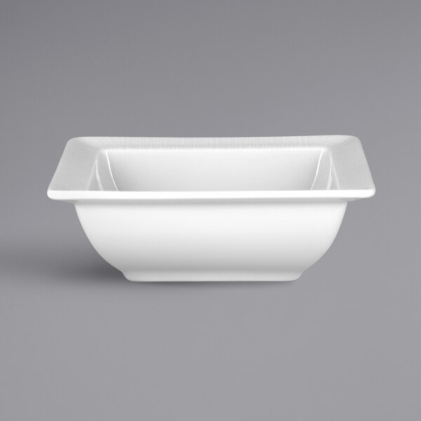 A white square bowl with an embossed square design.