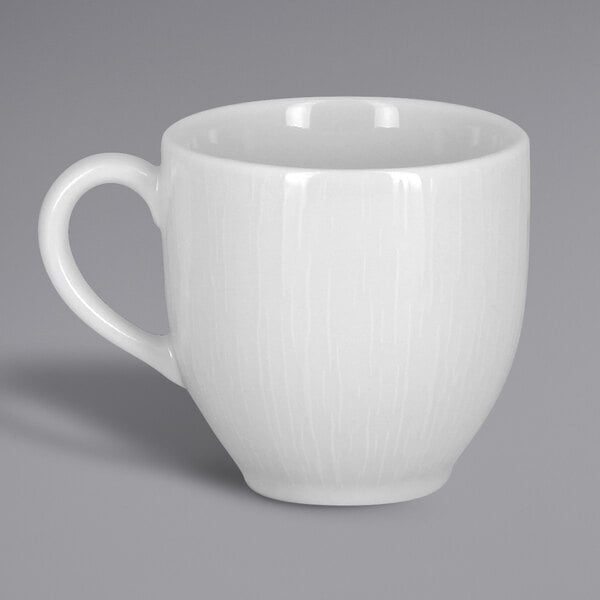 A close-up of a white RAK Porcelain Soul cup with a handle.