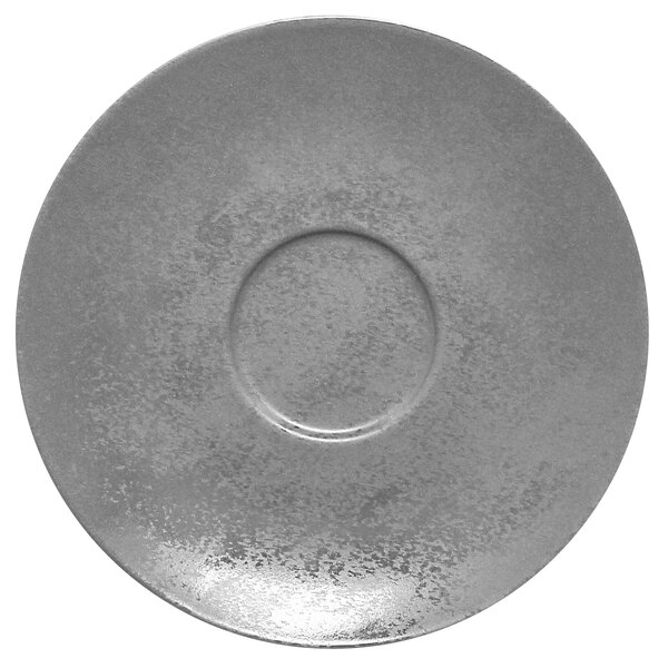 A close-up of a RAK Porcelain grey porcelain saucer with a circular hole in the middle.