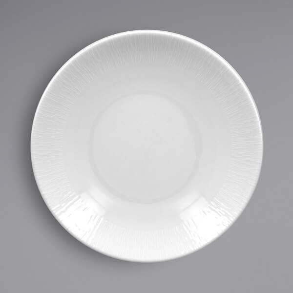 A white RAK Porcelain plate with a textured rim.