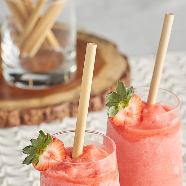 Two glasses of strawberry drinks with EcoChoice compostable reed straws.