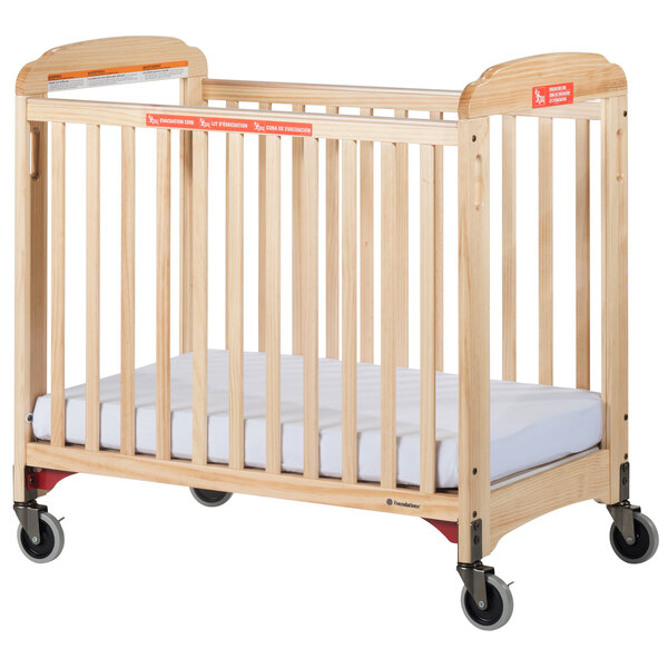A Foundations wooden evacuation crib with wheels.
