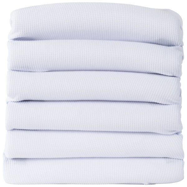 A stack of folded white Foundations ThermaLux baby blankets.