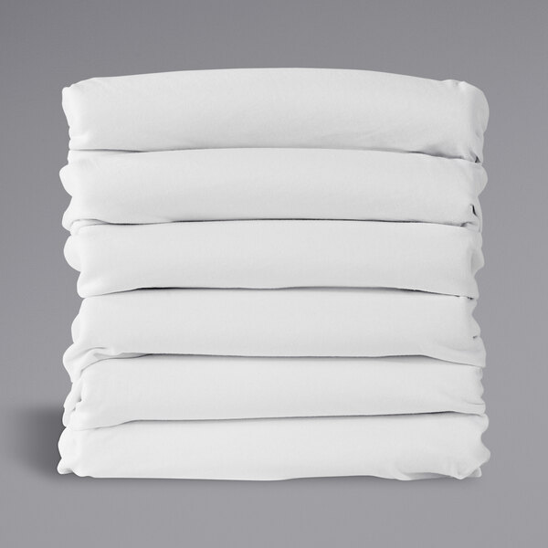 A stack of white rectangular Foundations SafeFit fitted sheets with a black border.