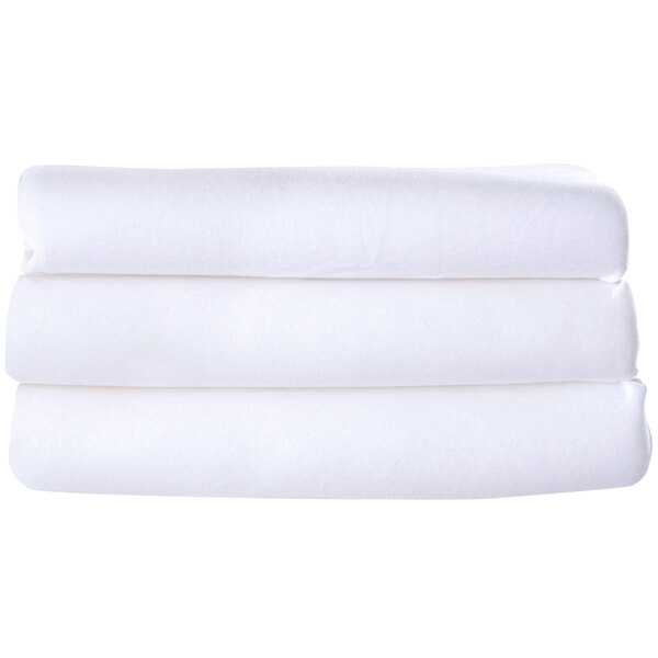 A stack of white compact washable microfiber playard covers.