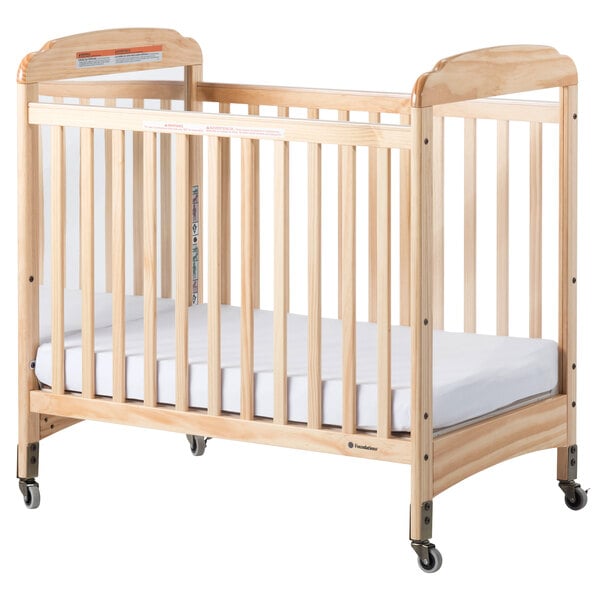 Foundations 2533040 Serenity 24" x 38" Natural Compact Fixed-Side Clearview / Mirror Wood Crib with Adjustable Mattress Board and 3" InfaPure Mattress