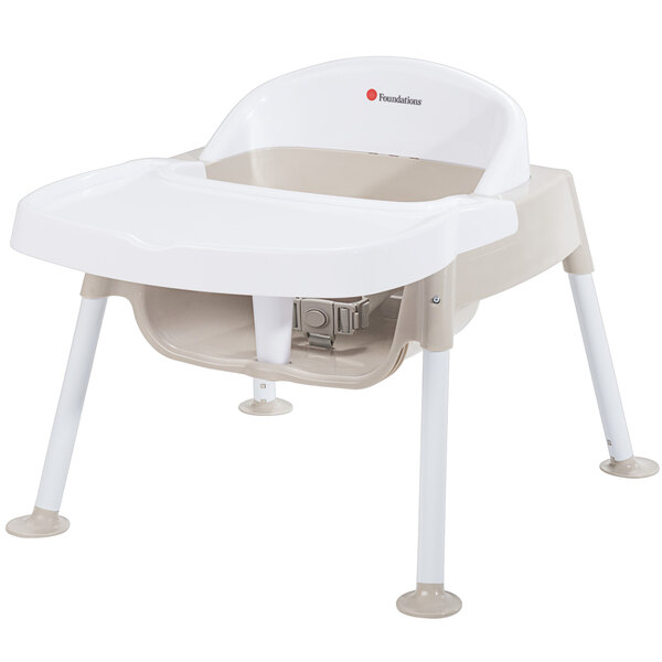 A white and tan Foundations Secure Sitter feeding chair.