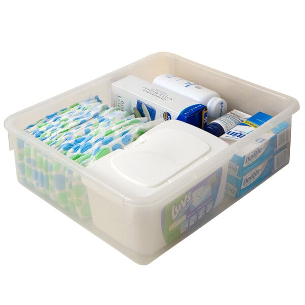 A clear plastic storage bin with a lid and items inside, including a bag of toothpaste.