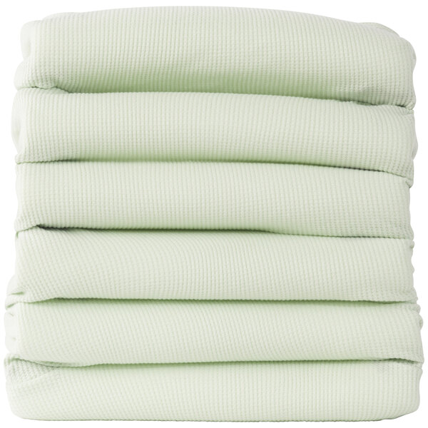 A stack of mint green Foundations baby blankets.