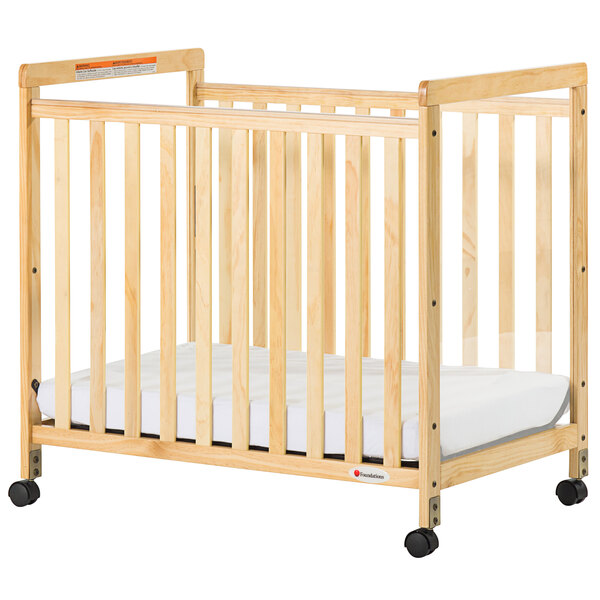 A Foundations SafetyCraft wooden crib with wheels.