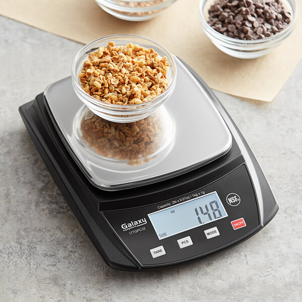 A Galaxy PC32 portion scale on a counter with a bowl of granola.
