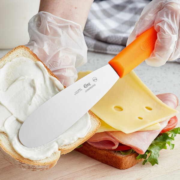 Choice 5 1/2 Smooth Stainless Steel Sandwich Spreader with Neon Orange  Polypropylene Handle