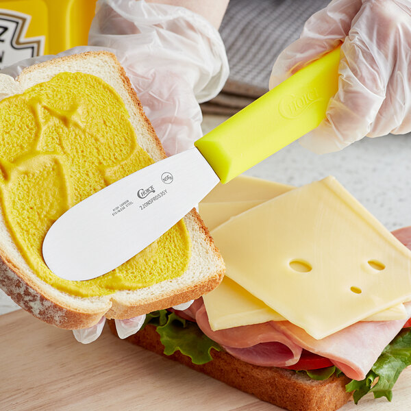 Choice 5 1/2 Smooth Stainless Steel Sandwich Spreader with Brown  Polypropylene Handle