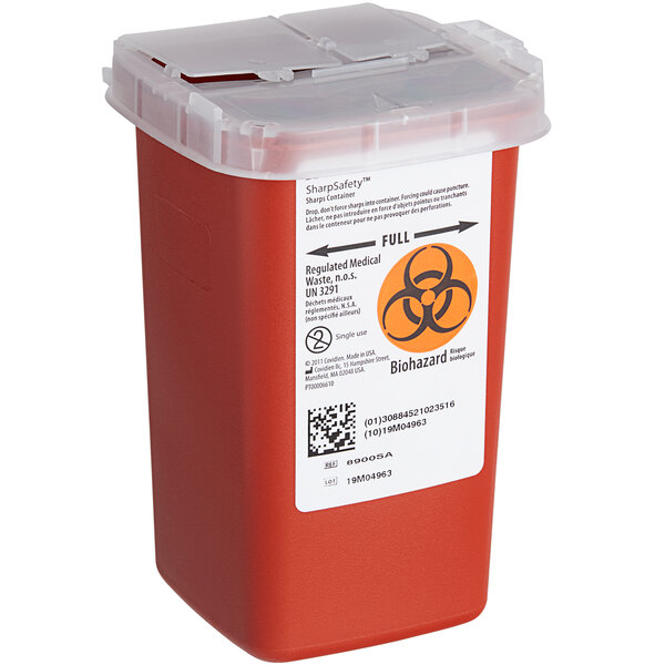 A red Medique 1 quart plastic sharps container with a biohazard label.