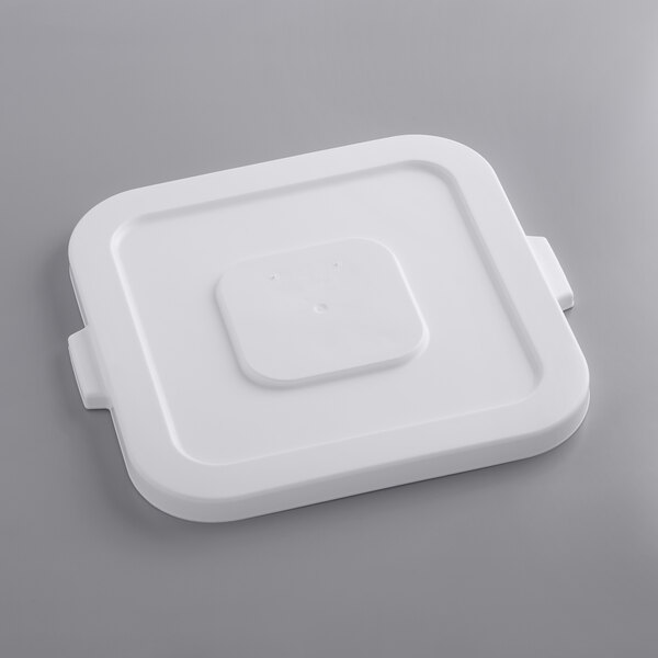 A white plastic lid on a white square ingredient bin.