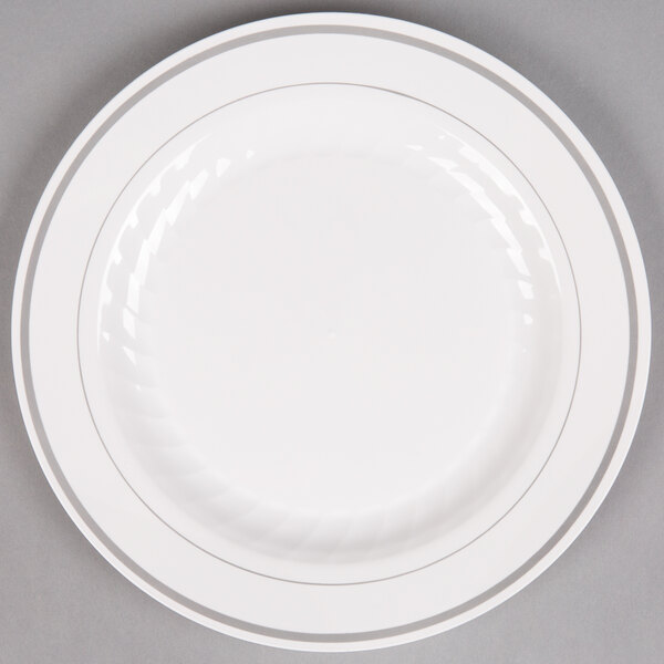 A white WNA Comet plastic plate with silver accent bands.