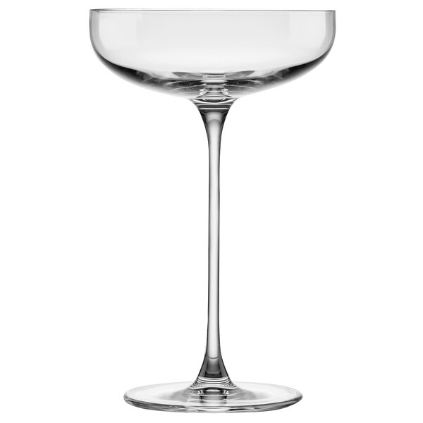 A Nude Savage clear glass wine glass with a long stem.