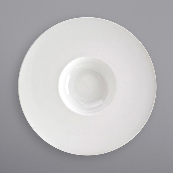 A close-up of a white bowl on a white plate.