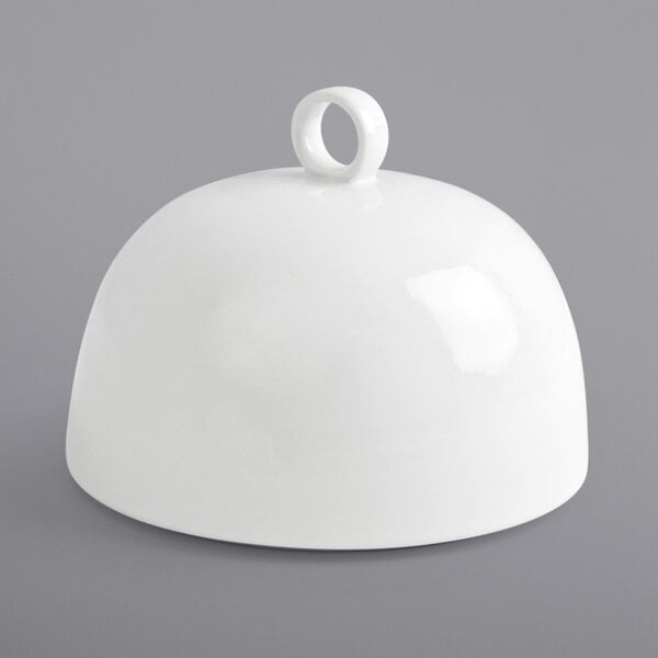 A bright white round porcelain cloche with a handle.