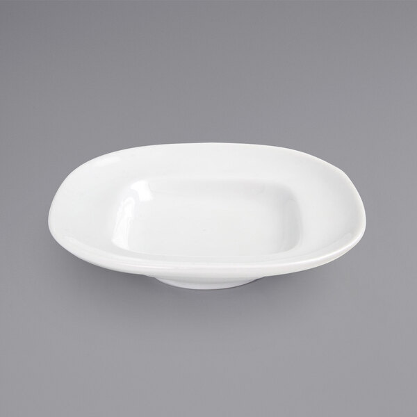 A Front of the House Trillium bright white square porcelain plate with a wide rim on a gray surface.