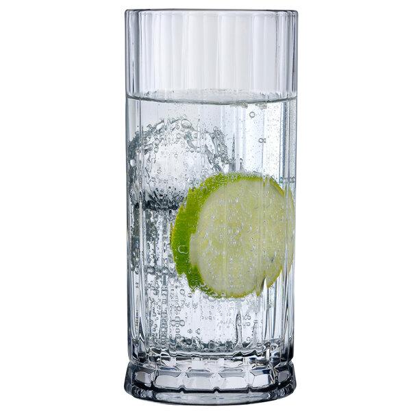 A Nude Wayne highball glass filled with water and a slice of lime.