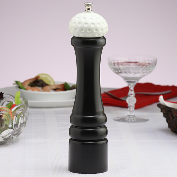 A black and white Chef Specialties pepper mill on a table.