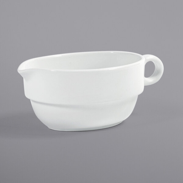 A white porcelain gravy boat with a handle.