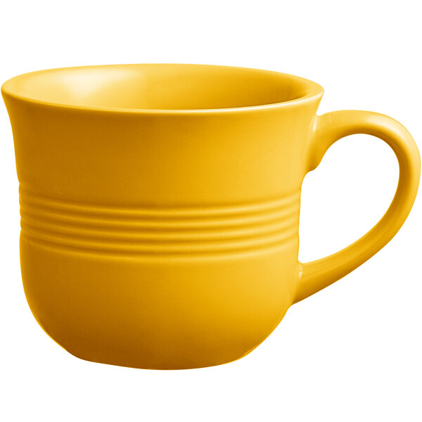 An Acopa Capri mango orange china cup with a handle on a white background.