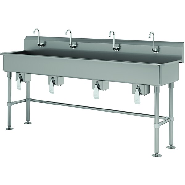 A stainless steel Advance Tabco multi-station hand sink with knee-operated faucets.