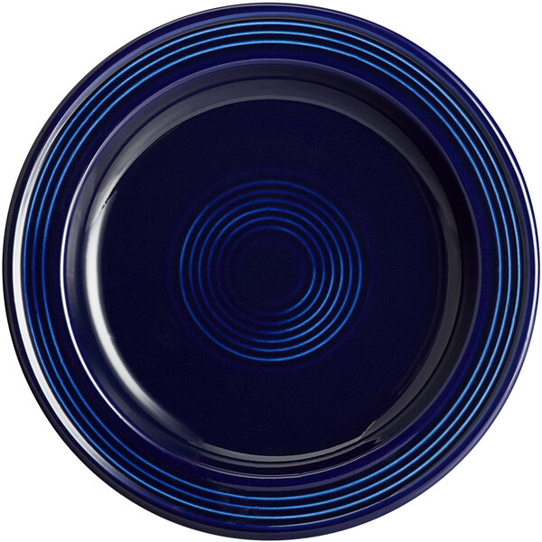 An Acopa Capri deep sea cobalt stoneware plate with blue lines on it.